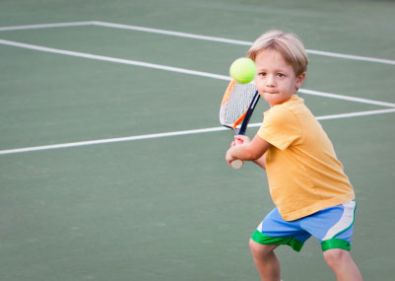 Мальчик играет в теннис